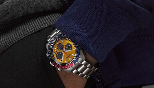 Seiko Prospex Speedtimer chronograph watch with yellow dial and Pepsi bezel worn on wrist, sporty stainless steel bracelet style